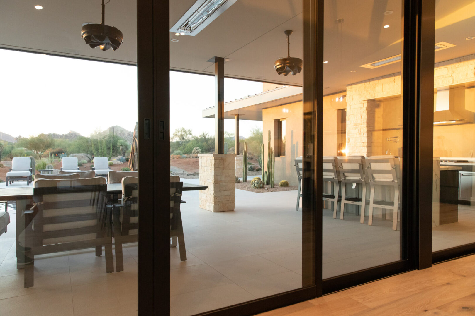 A patio with tables and chairs outside of it