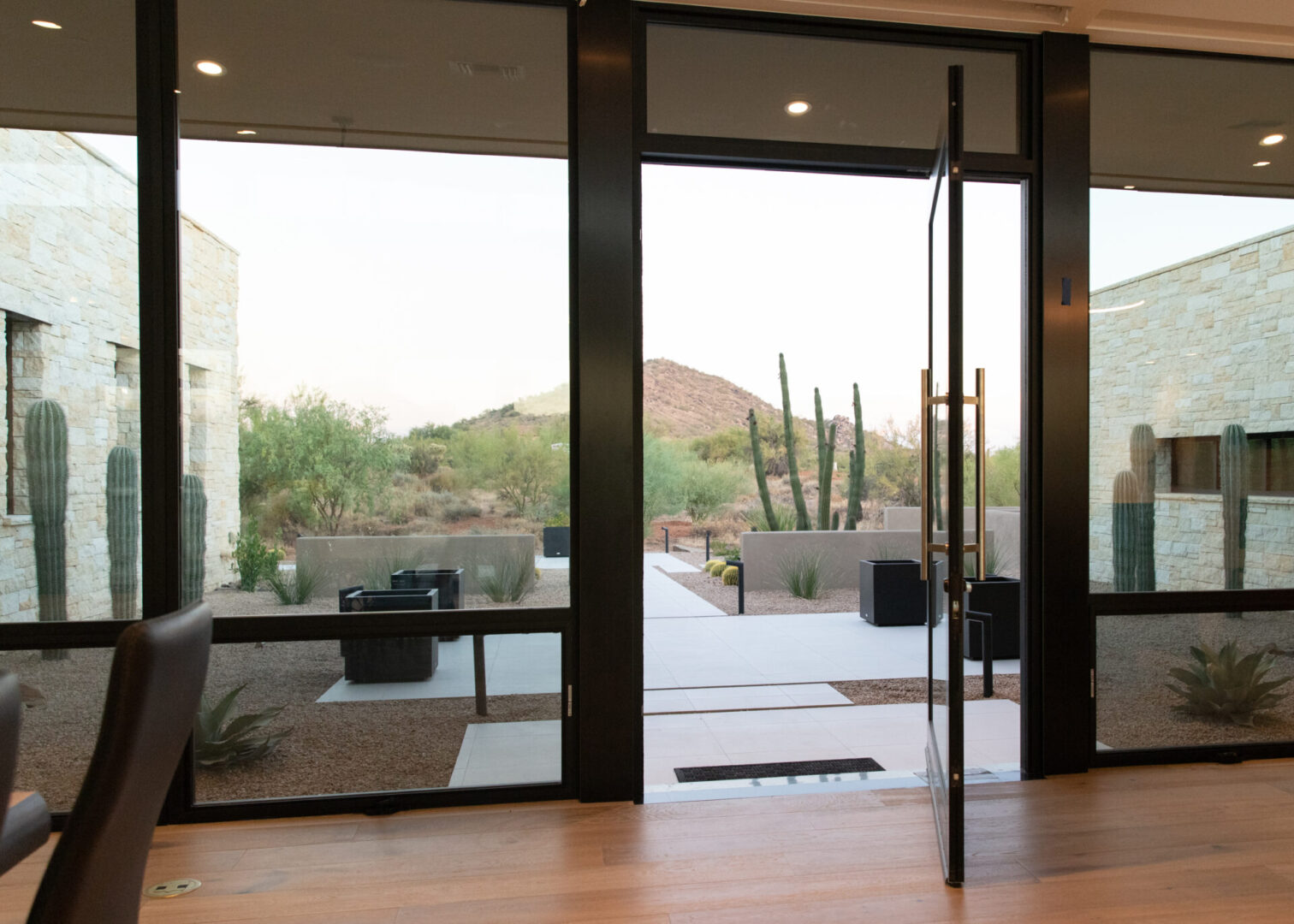 A large glass door with a view of the desert.