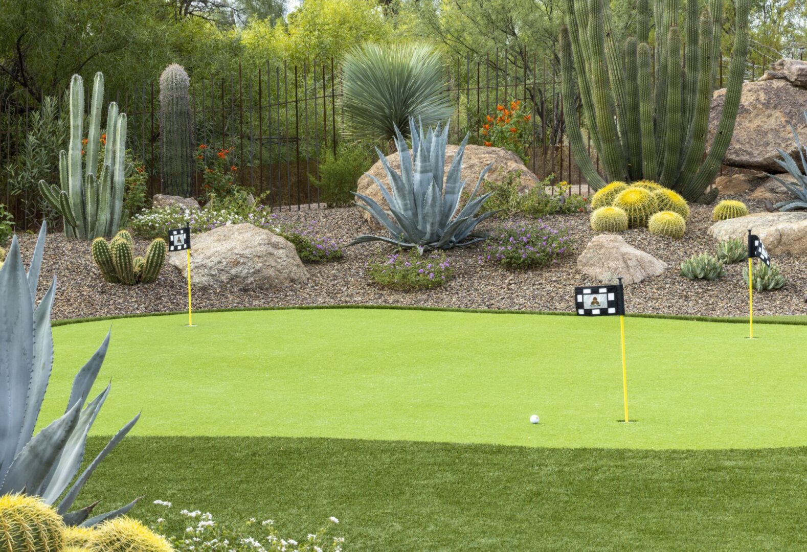 A golf course with a green and some sand