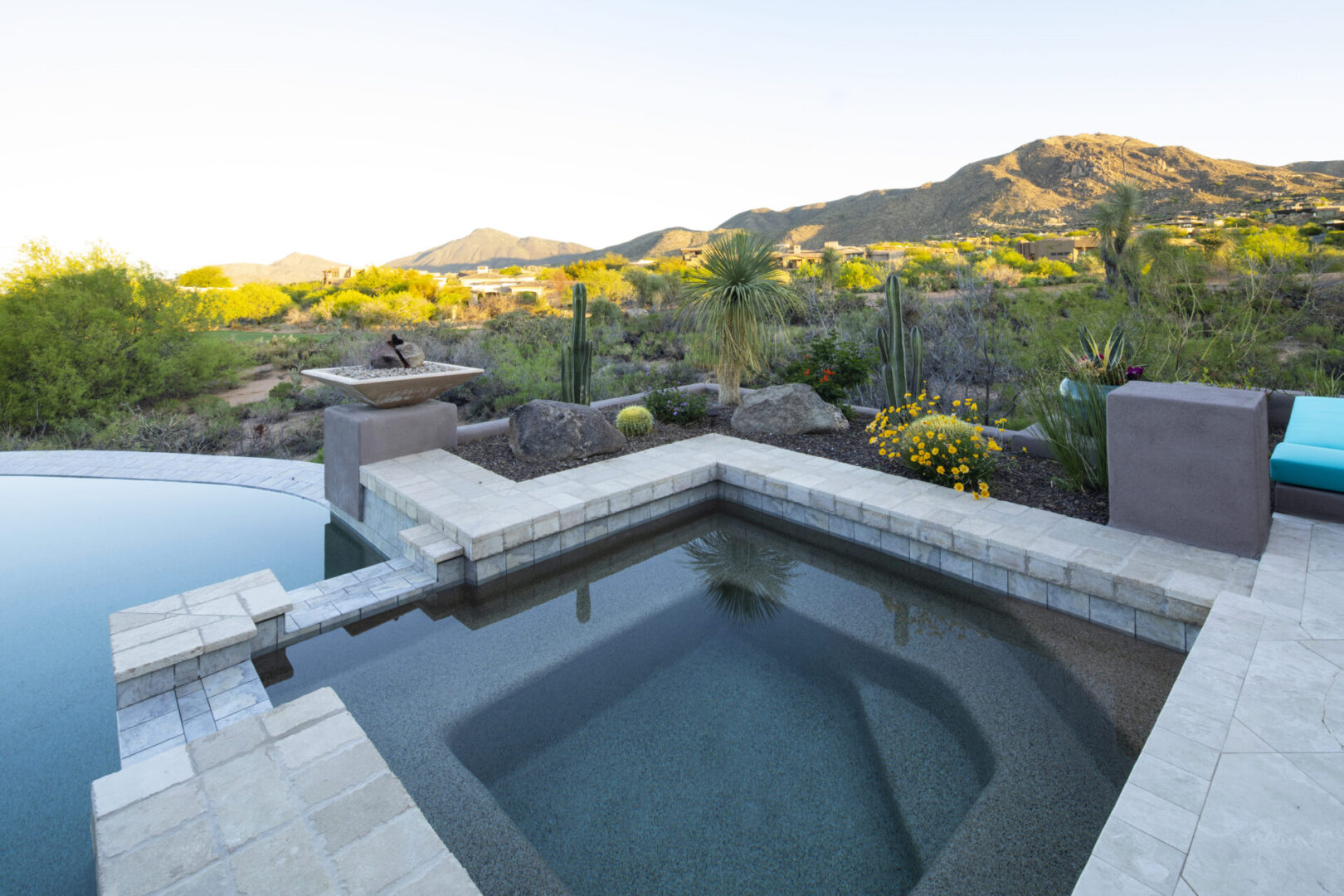 A pool with a view of the mountains and trees.