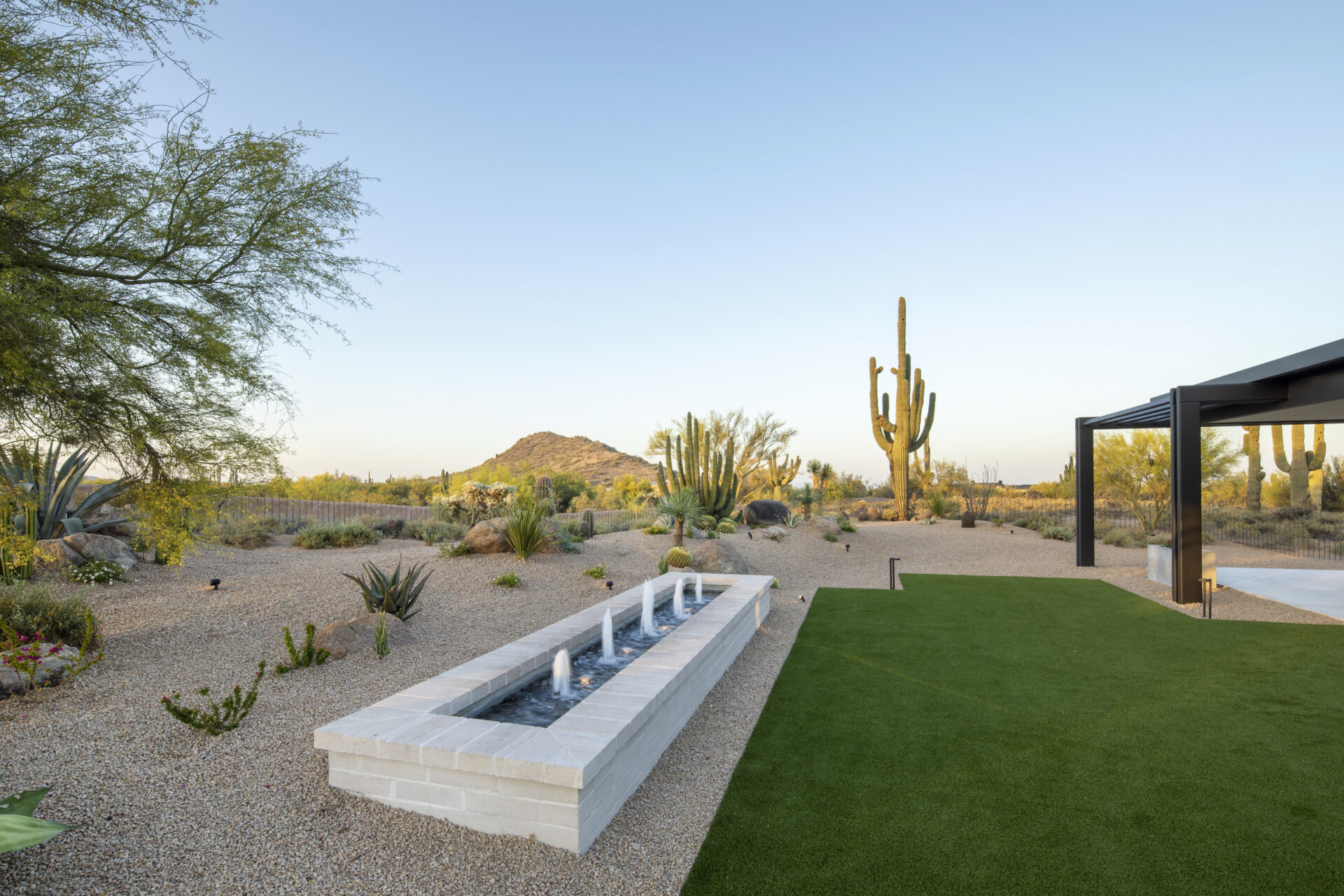 A fountain in the middle of a desert yard.