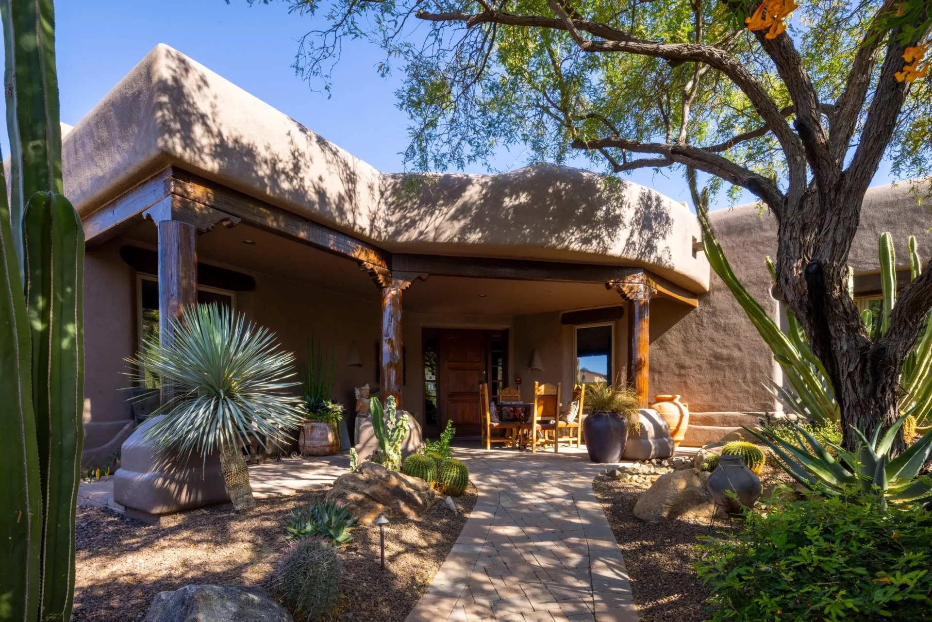 A house with a patio and rocks in the yard.