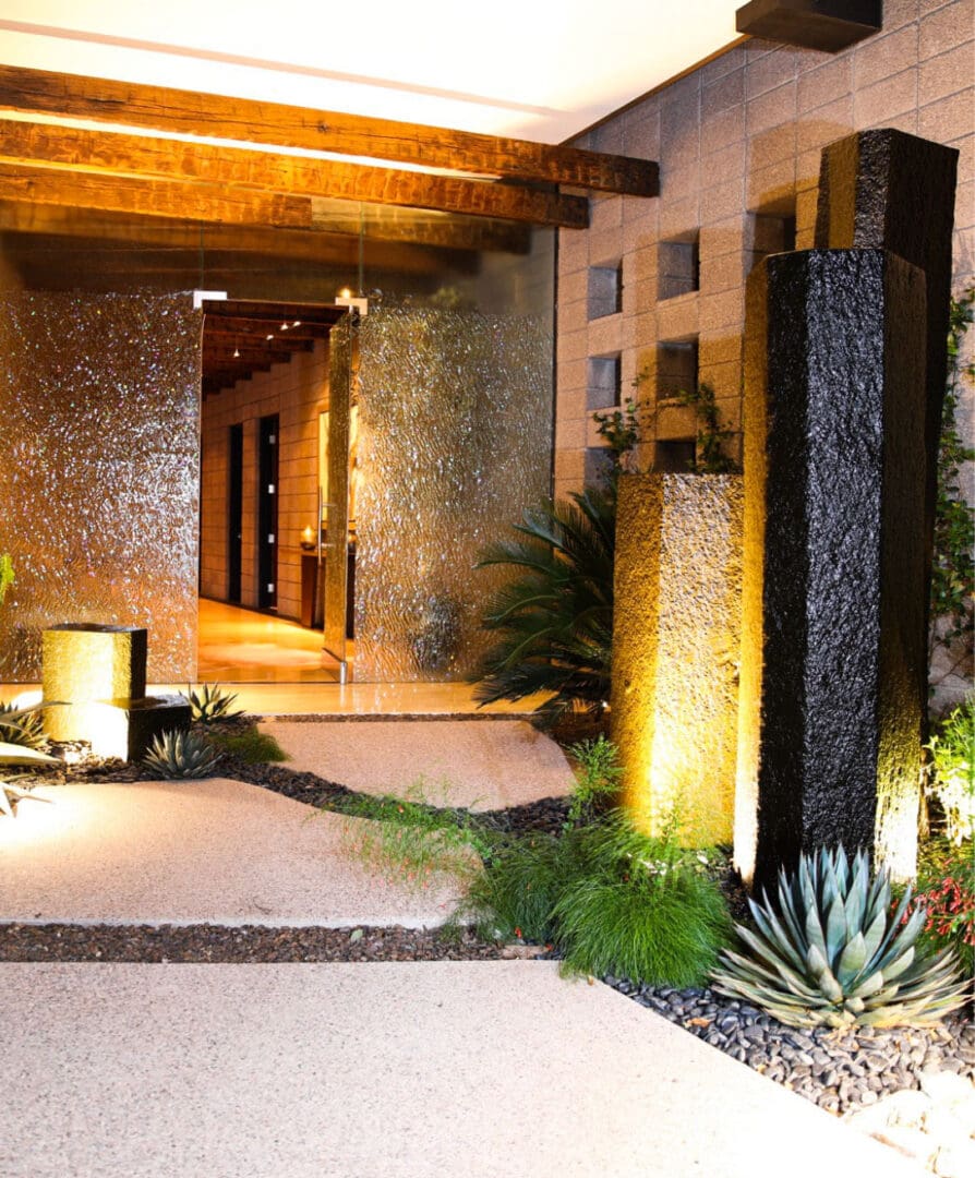 A modern entry way with lights and plants.