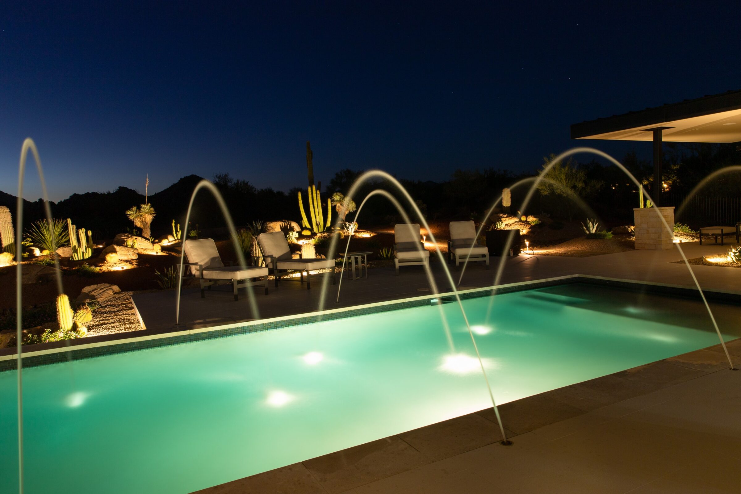 Luxury residential landscaping using lighted water jets.