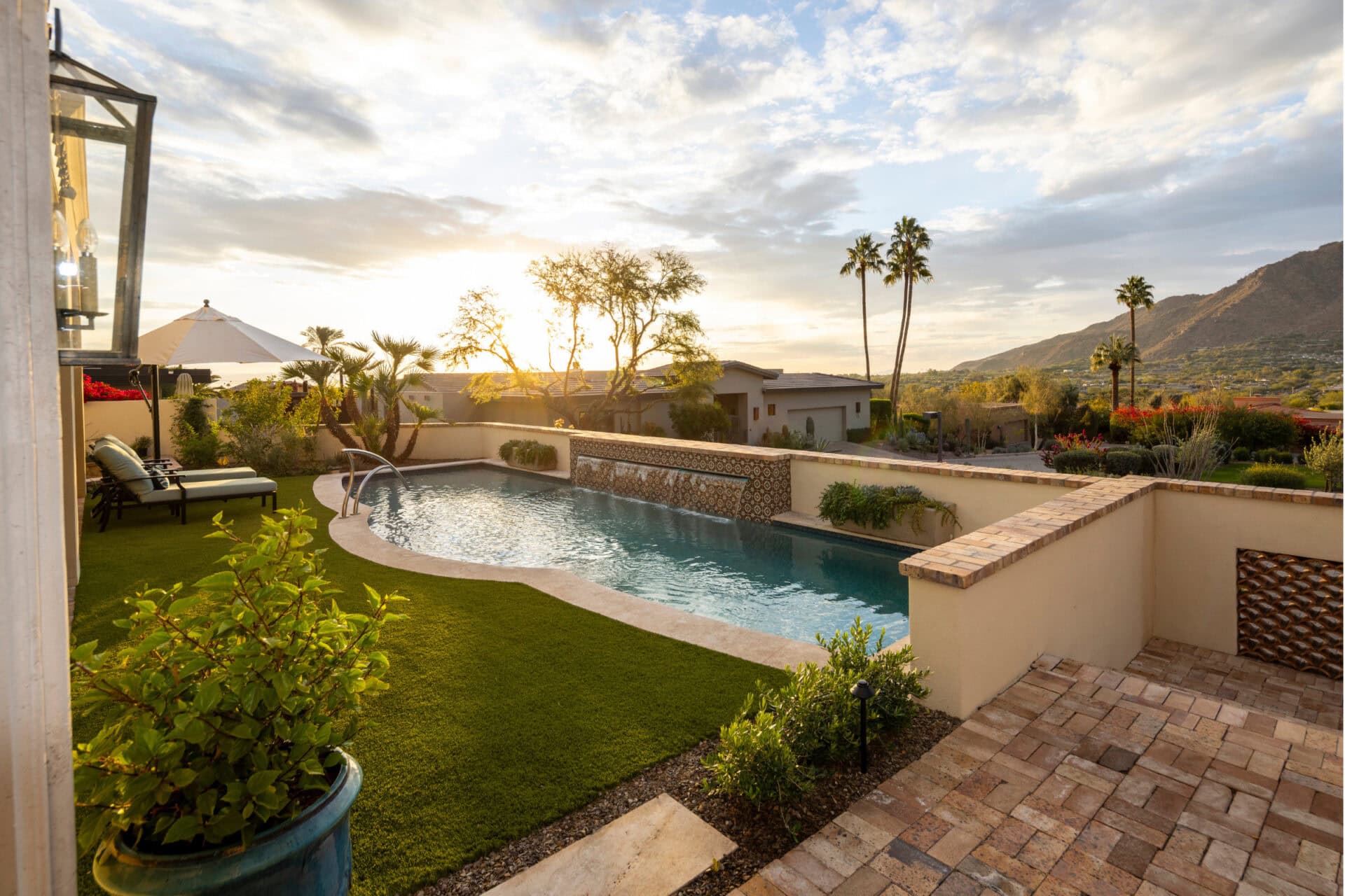 A backyard with outdoor living features including a pool.