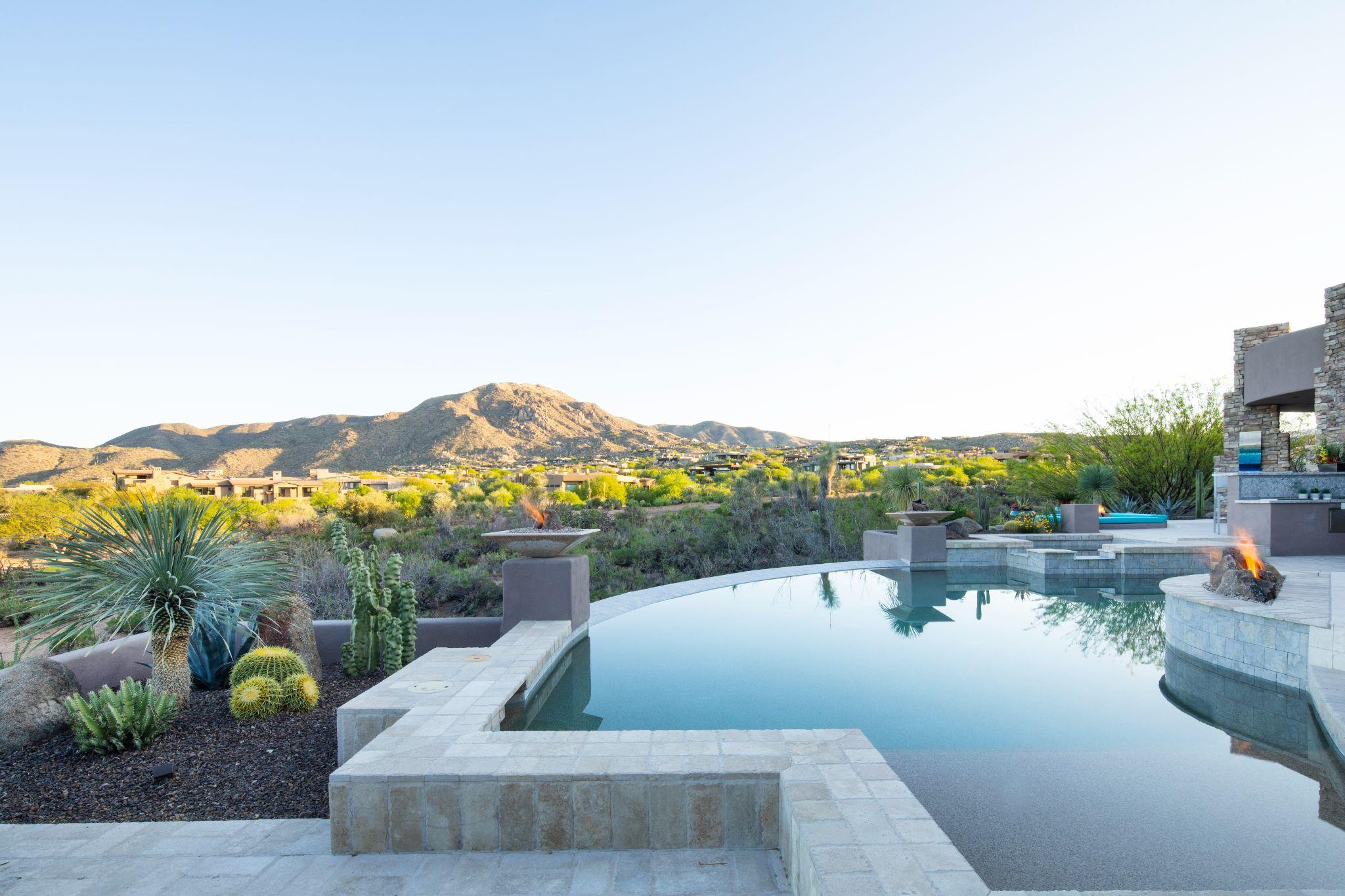 Desert hillside pool with clean lines and integrated fire features